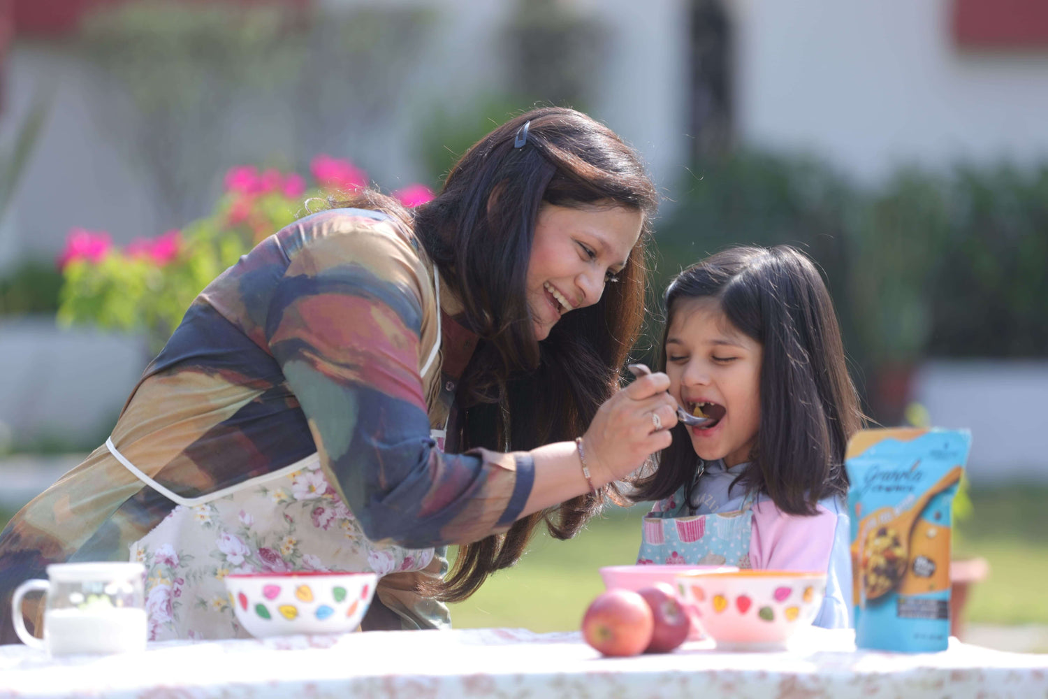 Akanksha feeding Granola Crunch to her daughter